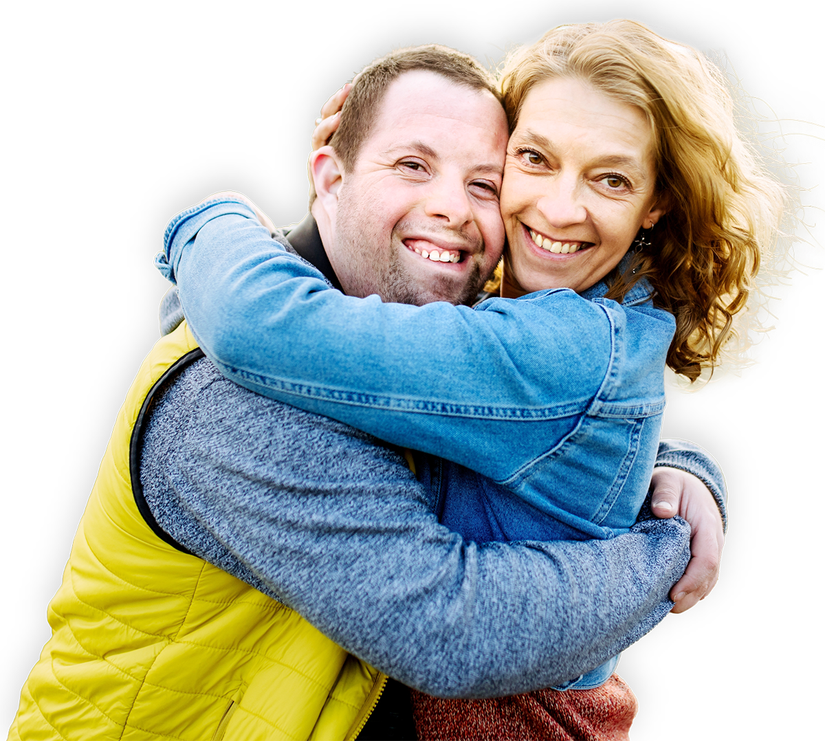 A man with Downs Syndrome hugging a woman and smiling.